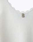 Knit top with scalloped edges