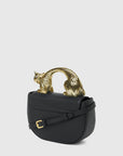 MiLA Boutique black leather Choupette top handle bag with gold cat-shaped handle and adjustable strap.