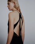 MiLA Boutique black satin halterneck dress with plunging neckline and open back with georgette details.