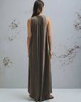 MiLA Boutique brown crinkle twill maxi dress with scoop neck and asymmetrical hem, worn by a model.