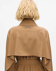 MiLA Boutique camel trench coat with cape detail and pleated skirt. Features a spread collar and buckle belt.