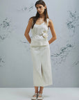 MiLA Boutique cream crinkle twill sleeveless top with rounded neckline and fabric flower accent.