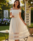 MiLA Boutique cream off-the-shoulder midi dress with lace trim inserts on skirt. Model wearing dress outdoors.