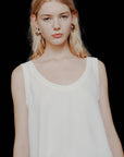 MiLA Boutique cream satin vest top with rounded neckline and spaghetti straps, worn by a blonde model.