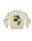 MiLA Boutique cream knit sweater with a large yellow sunflower, green leaves, peace sign, and heart graphic.