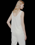MiLA Boutique ivory satin vest top with rounded neckline and spaghetti straps, worn by a model.