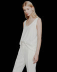 MiLA Boutique light ivory satin vest top with rounded neckline and spaghetti straps, paired with cream trousers.