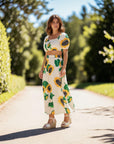 MiLA Boutique white cotton poplin crop top with sunflower print, square neckline, and puff sleeves.