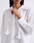 MiLA Boutique white cotton poplin shirt with a detachable neckerchief featuring ruffled ends and a fabric flower detail.