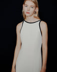 MiLA Boutique white envers satin halterneck dress with black trim and backless design.