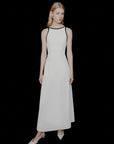 MiLA Boutique white envers satin maxi dress with black trim halterneck and backless design, worn by a model.