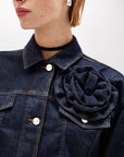 Denim jacket with rose-shaped pin