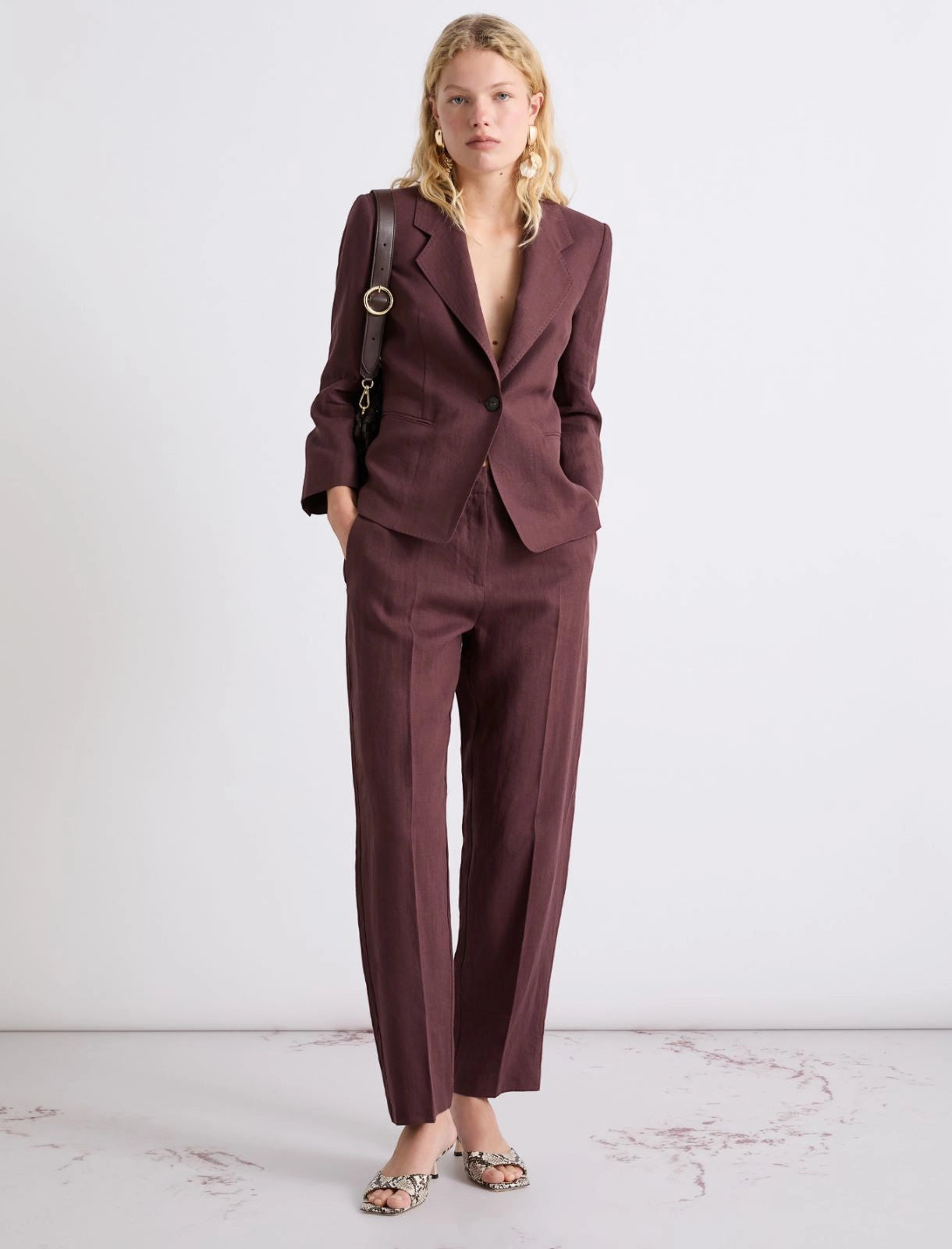 MiLA Boutique burgundy linen canvas chino trousers with a relaxed fit and sharp creases. Model wears them with a matching blazer.