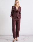 MiLA Boutique burgundy linen canvas chino trousers with a relaxed fit and sharp creases. Model wears them with a matching blazer.