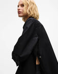 MiLA Boutique black cotton shirt with pointed collar, split side seams and button details. Model is wearing the shirt.
