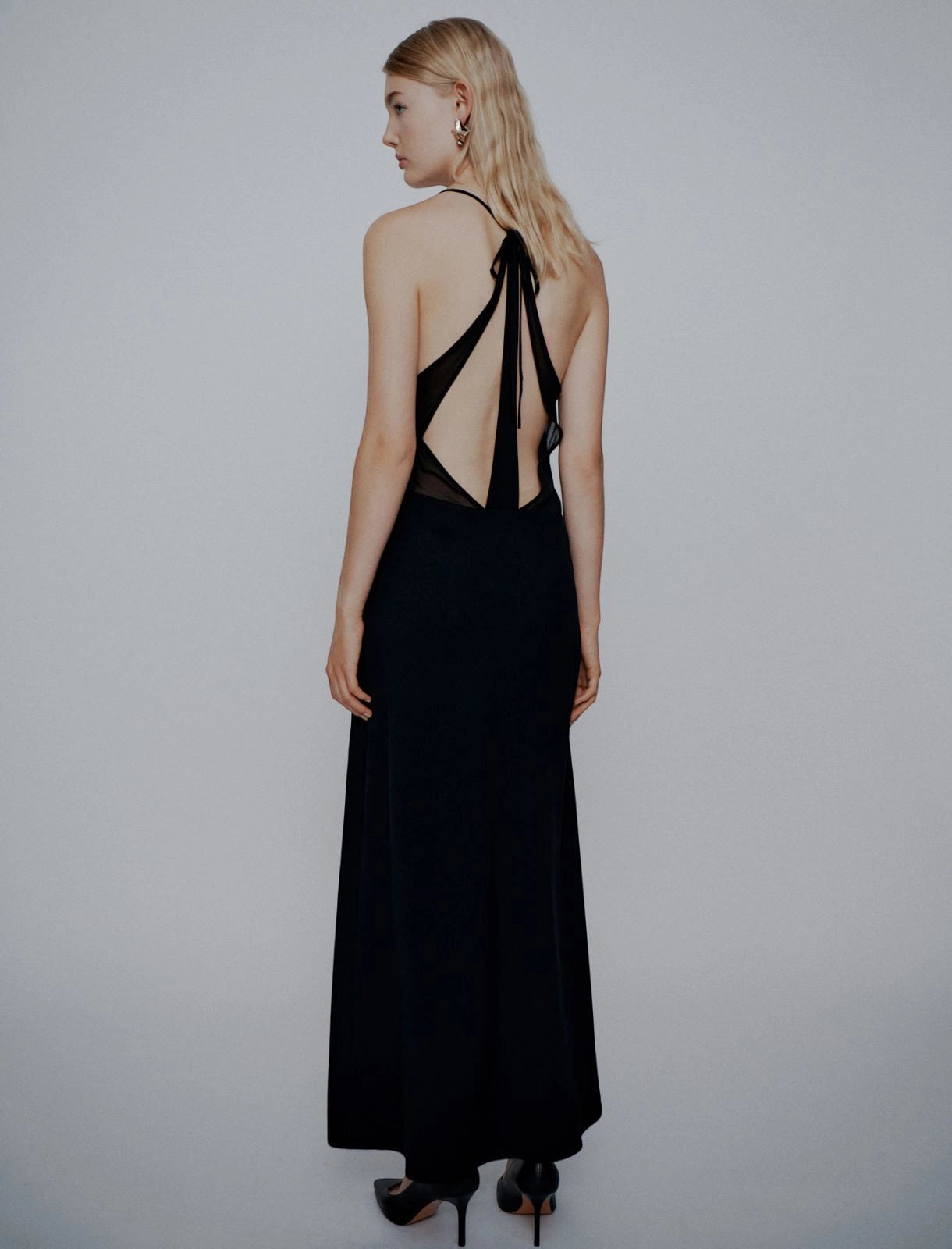 MiLA Boutique black long envers satin dress with halterneck, plunging neckline, and open back with tie detail.