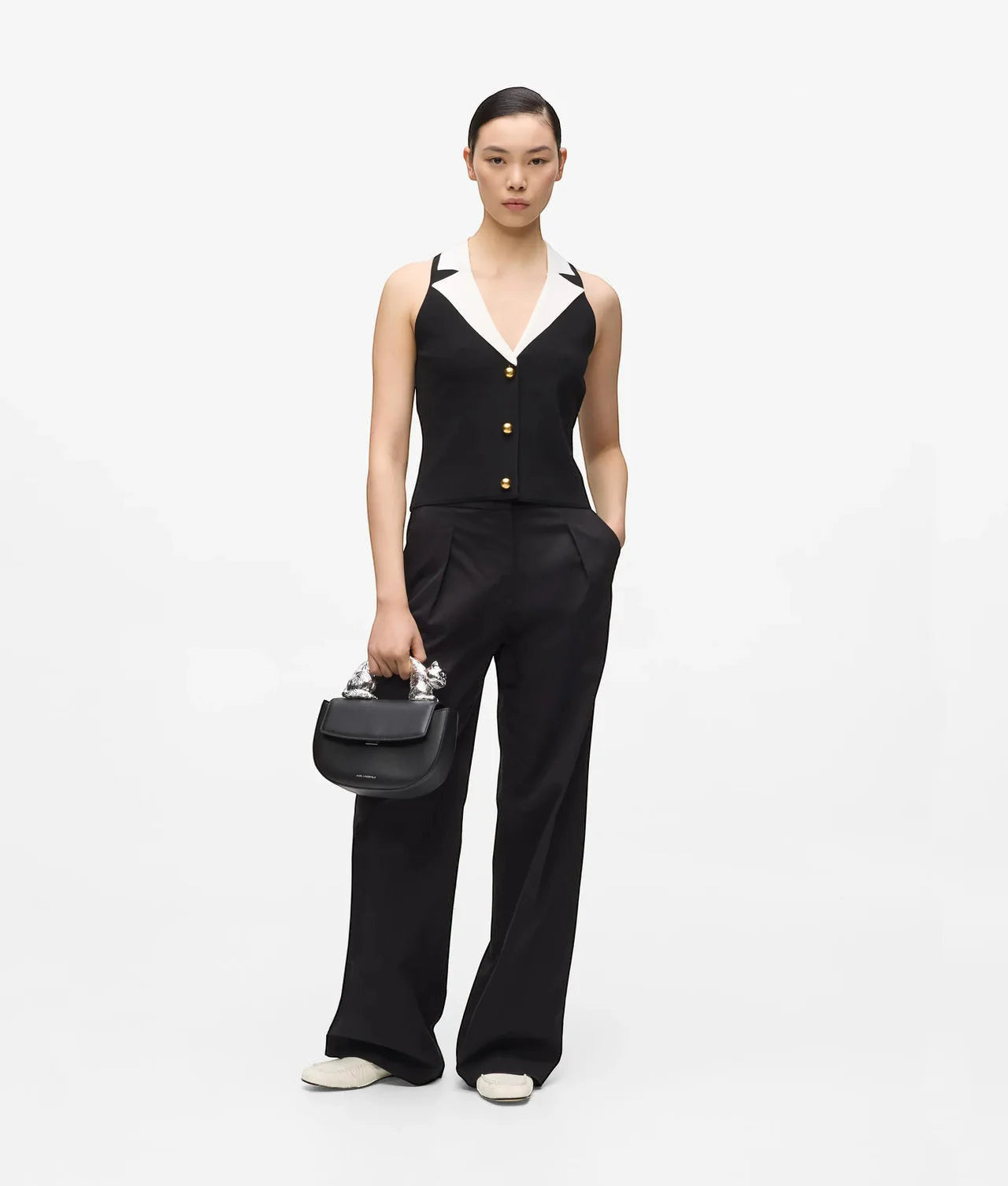 MiLA Boutique black sleeveless knit top with white collar and gold buttons, paired with black trousers.