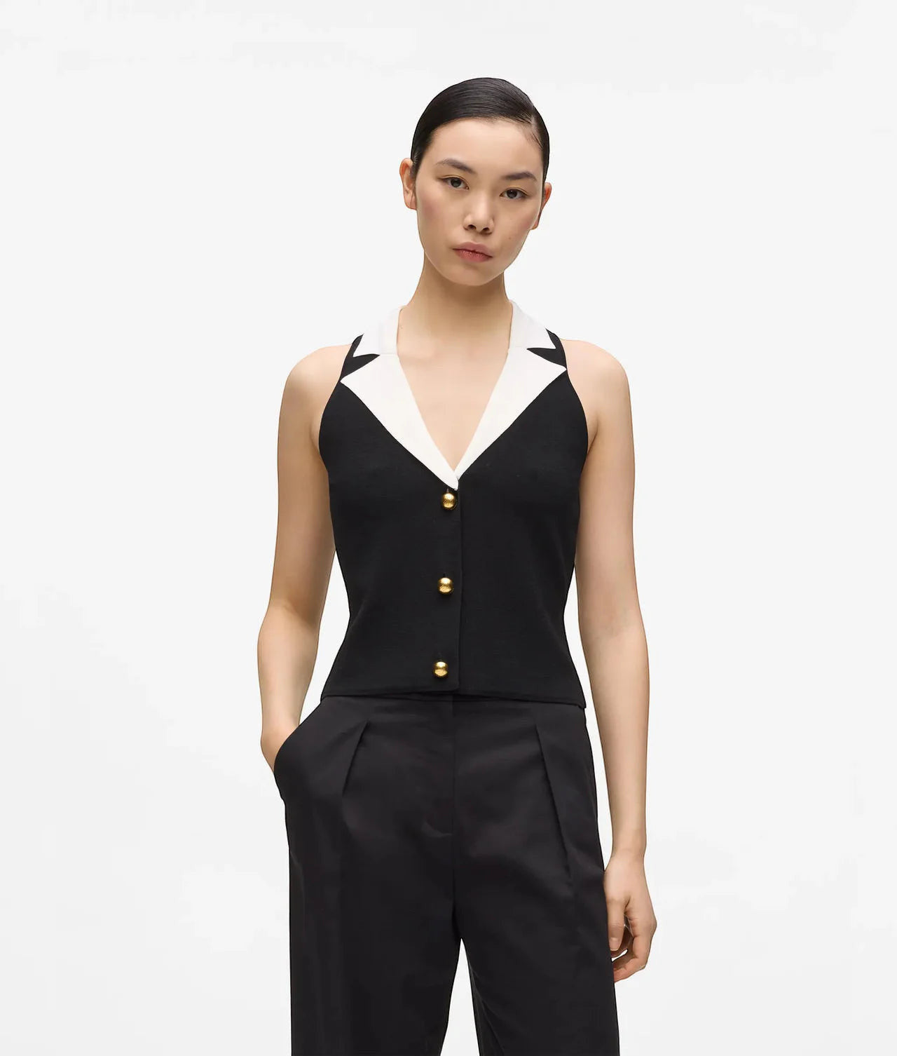 MiLA Boutique sleeveless black knit top with white collar and gold button detail.