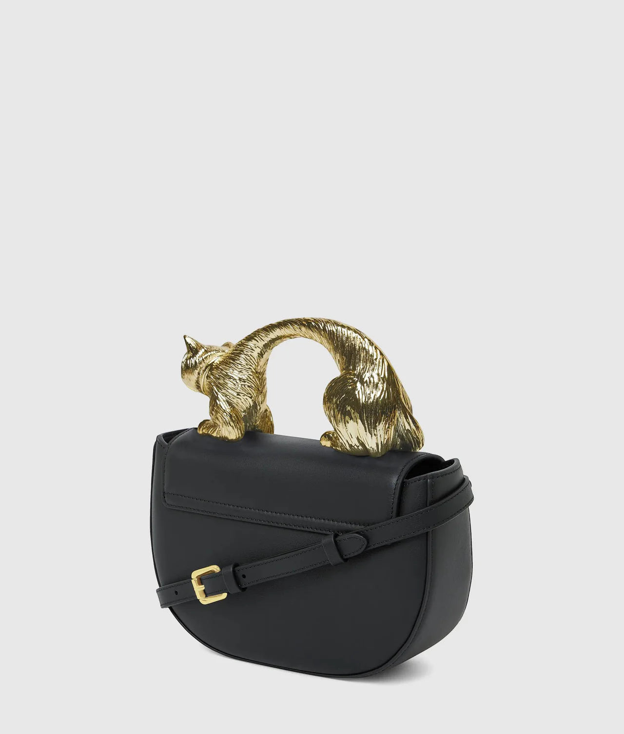 MiLA Boutique black leather Choupette top handle bag with gold cat-shaped handle and adjustable strap.