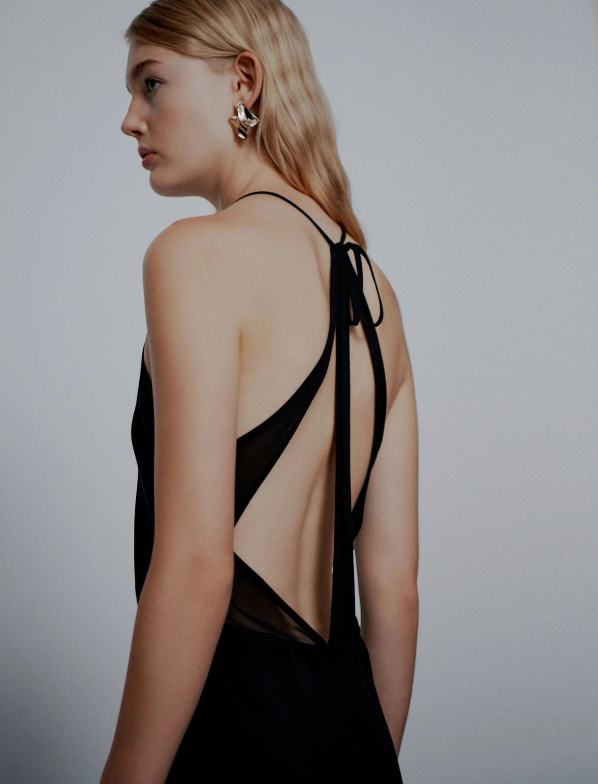 MiLA Boutique black satin halterneck dress with plunging neckline and open back with georgette details.