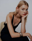 MiLA Boutique black satin halterneck dress with plunging neckline and double shoulder straps, worn by a model.