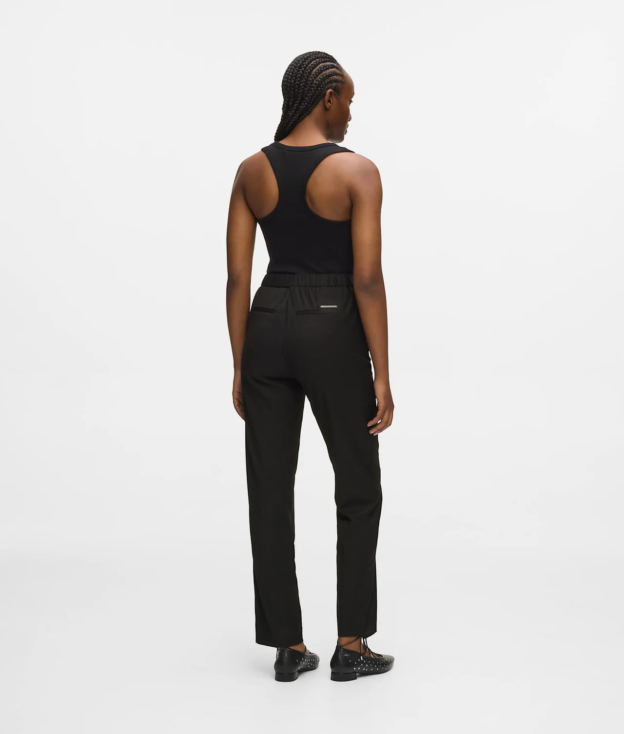 MiLA Boutique black wool-blend tailored pants with elasticated back waistband and Karl Lagerfeld logo rivet.