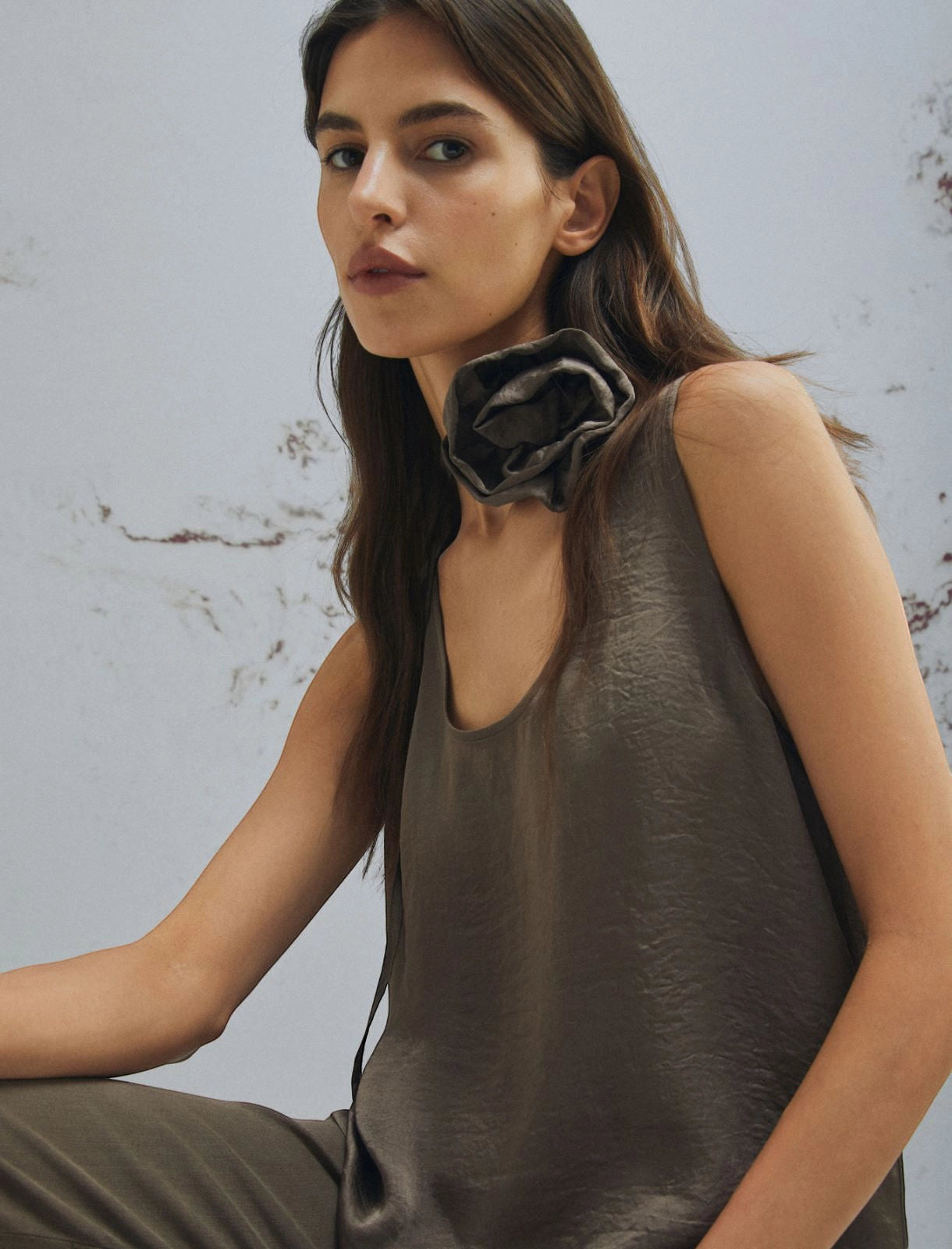 MiLA Boutique brown crinkle twill sleeveless top with rounded neckline and fabric flower accent.