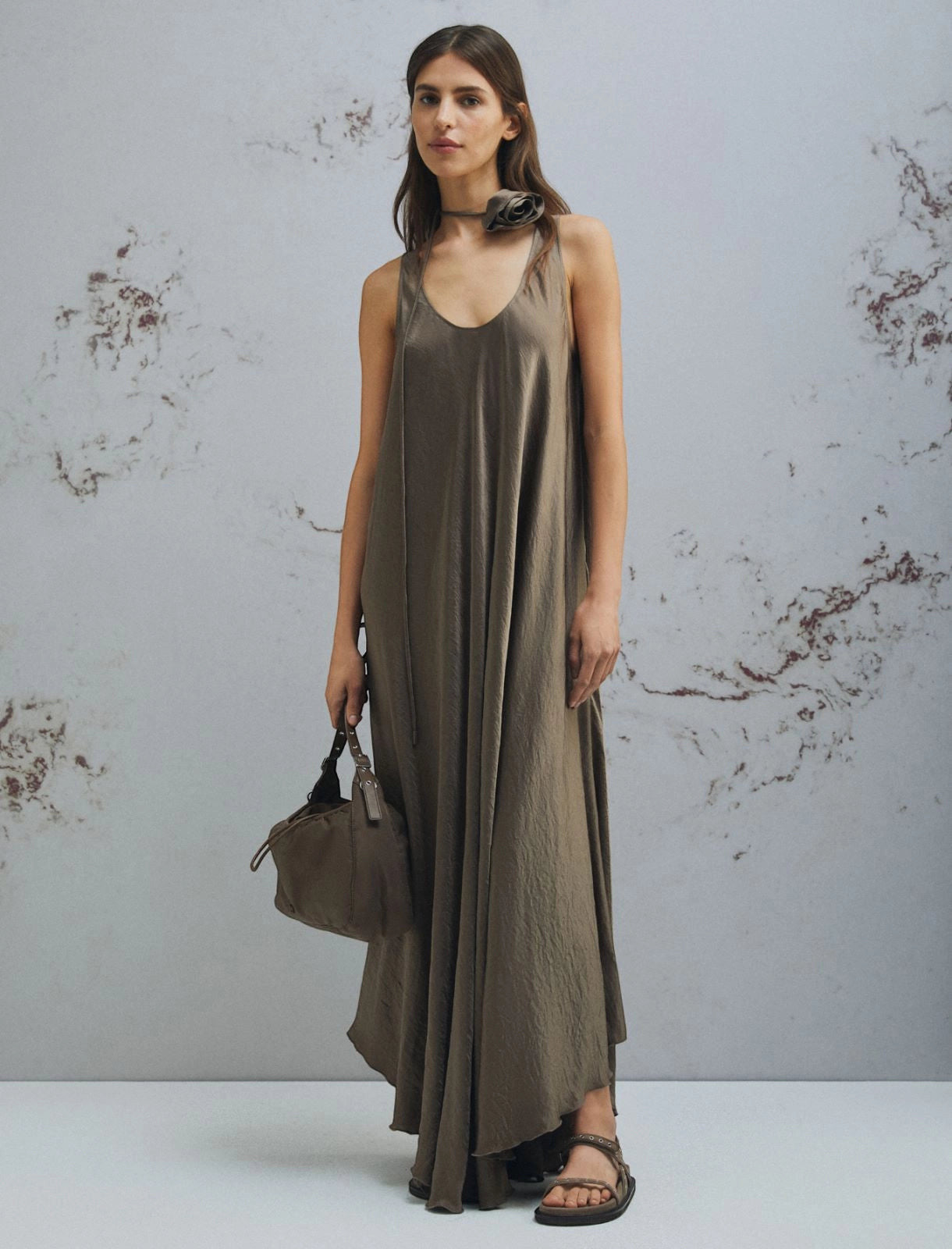 MiLA Boutique brown crinkle twill maxi dress with scoop neck, asymmetrical hem, and fabric belt with flower detail.