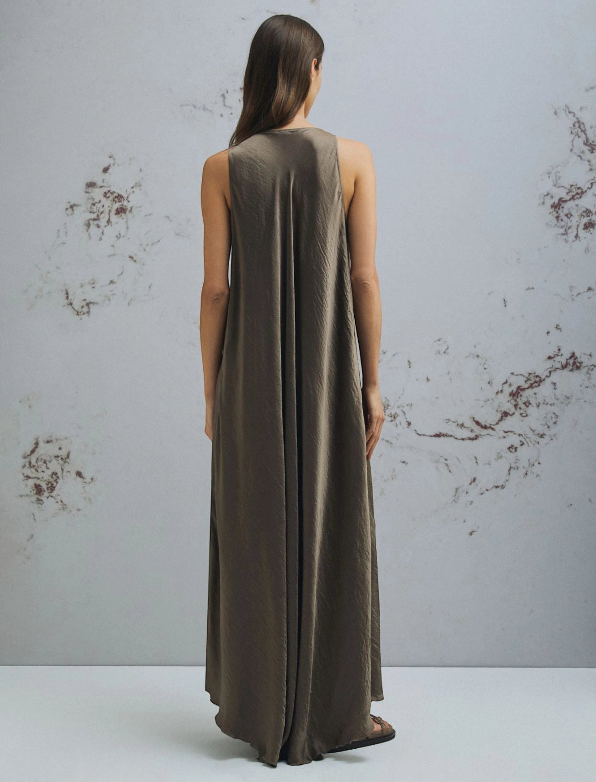 MiLA Boutique brown crinkle twill maxi dress with scoop neck and asymmetrical hem, worn by a model.