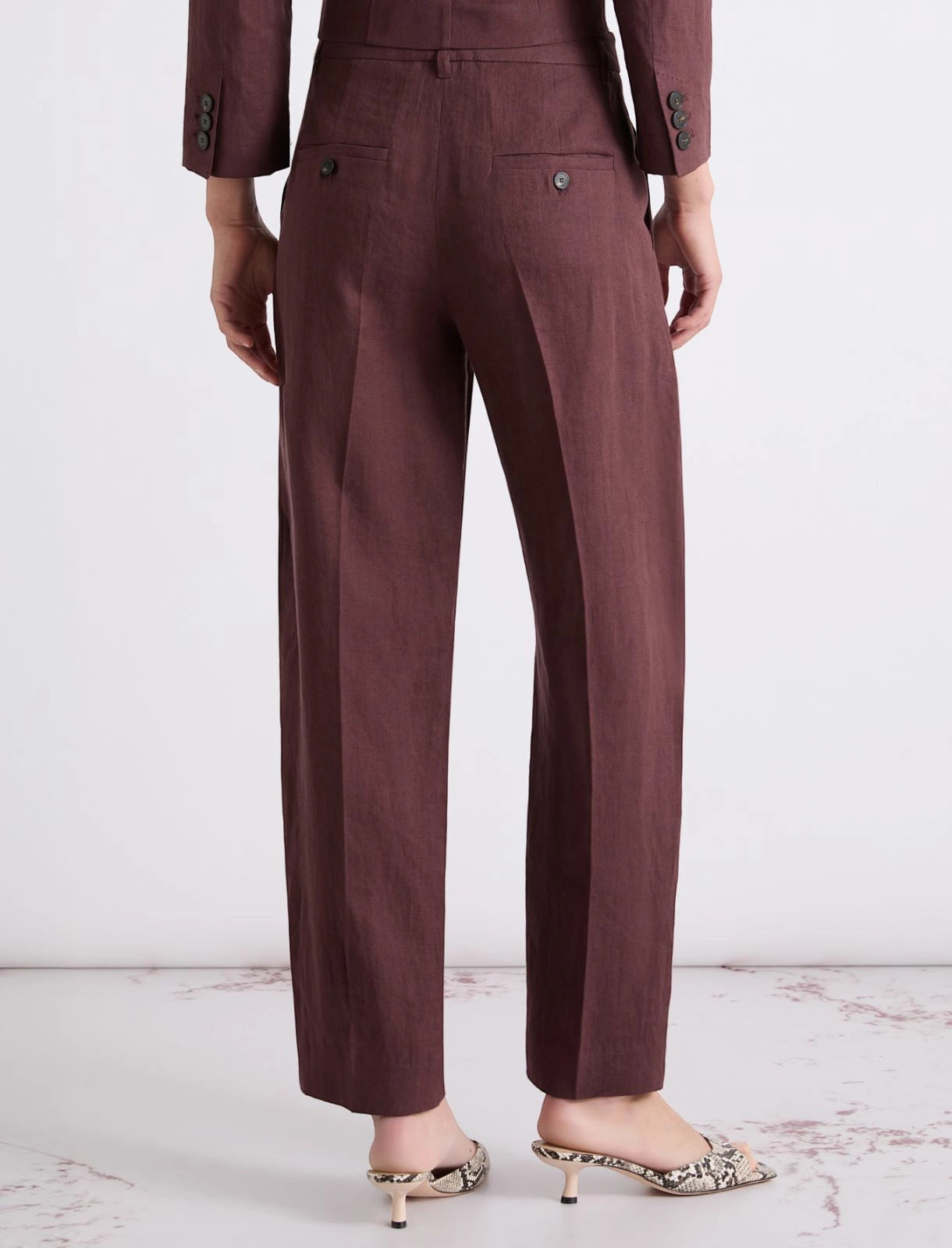 MiLA Boutique burgundy linen canvas chino trousers with a relaxed fit, hook and zip fastening, and sharp creases.
