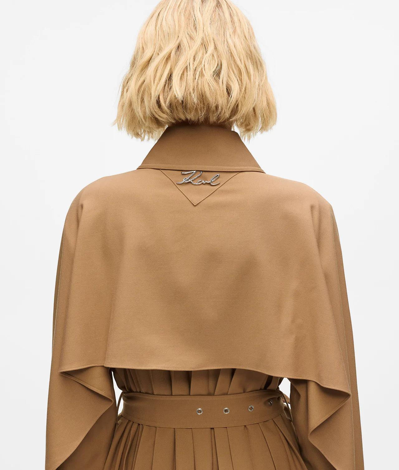 MiLA Boutique camel trench coat with cape detail and pleated skirt. Features a spread collar and buckle belt.