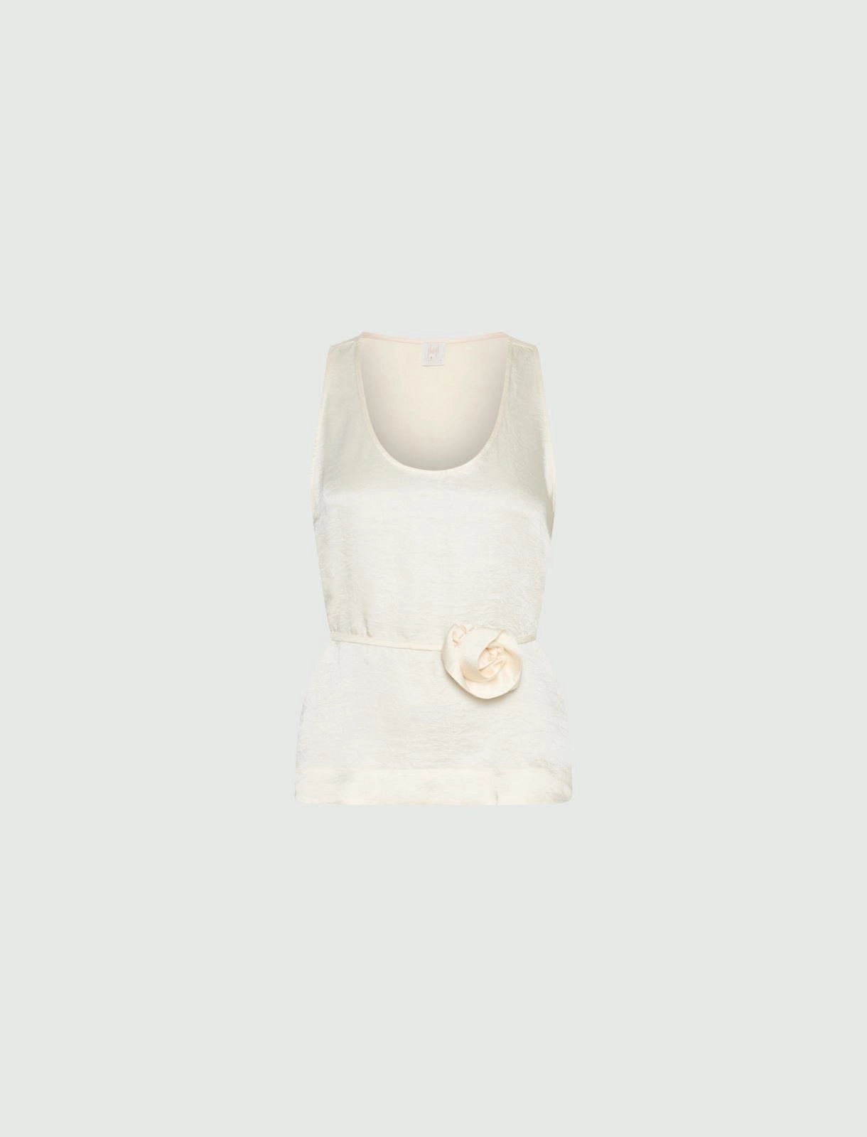 MiLA Boutique cream crinkle twill sleeveless top with rounded neckline and fabric flower accent.