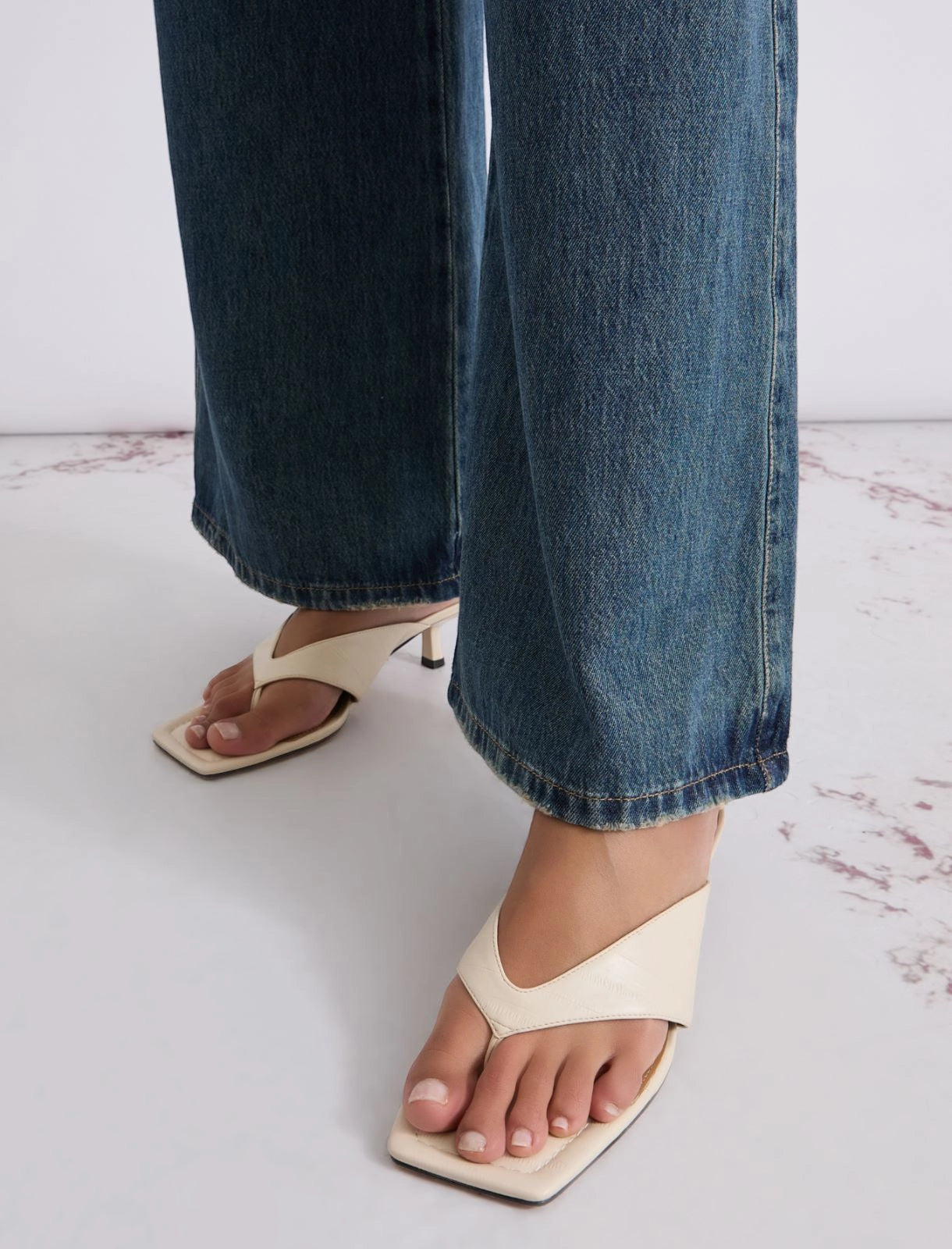MiLA Boutique cream leather square-toe thong sandals with a 4cm lacquered heel, worn with denim.