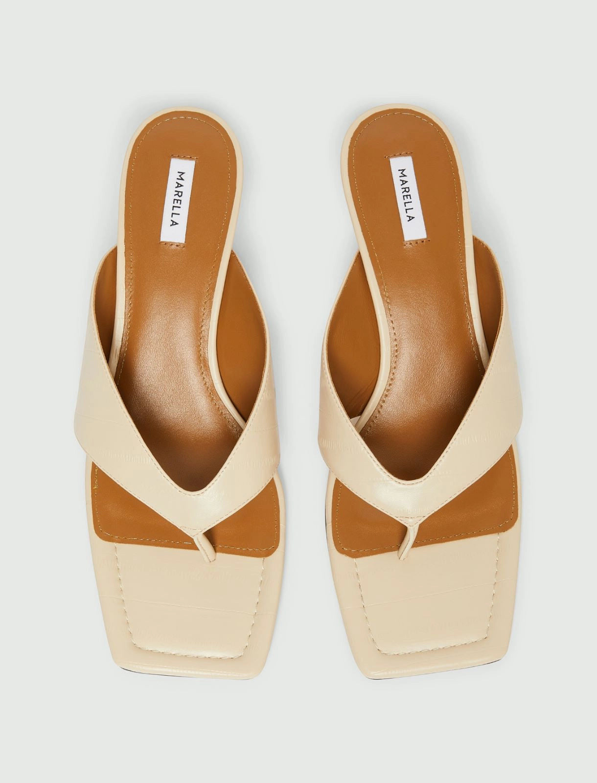 MiLA Boutique cream square-toe flip flops with reptile-print straps and brown leather lining.