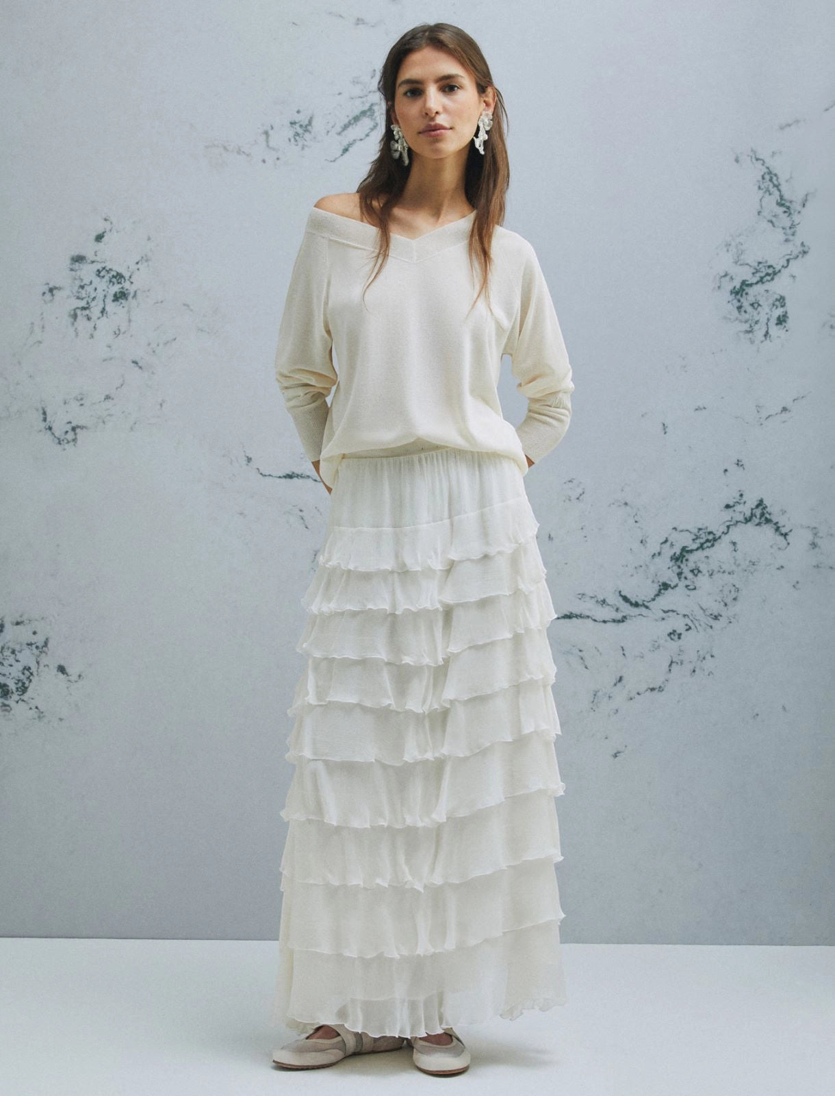 MiLA Boutique cream V-neck sweater with raglan sleeves and slip-stitch detailing, worn by a model with a ruffled white skirt.