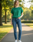 MiLA Boutique emerald green knit top with crew neck and subtle side texture detailing.