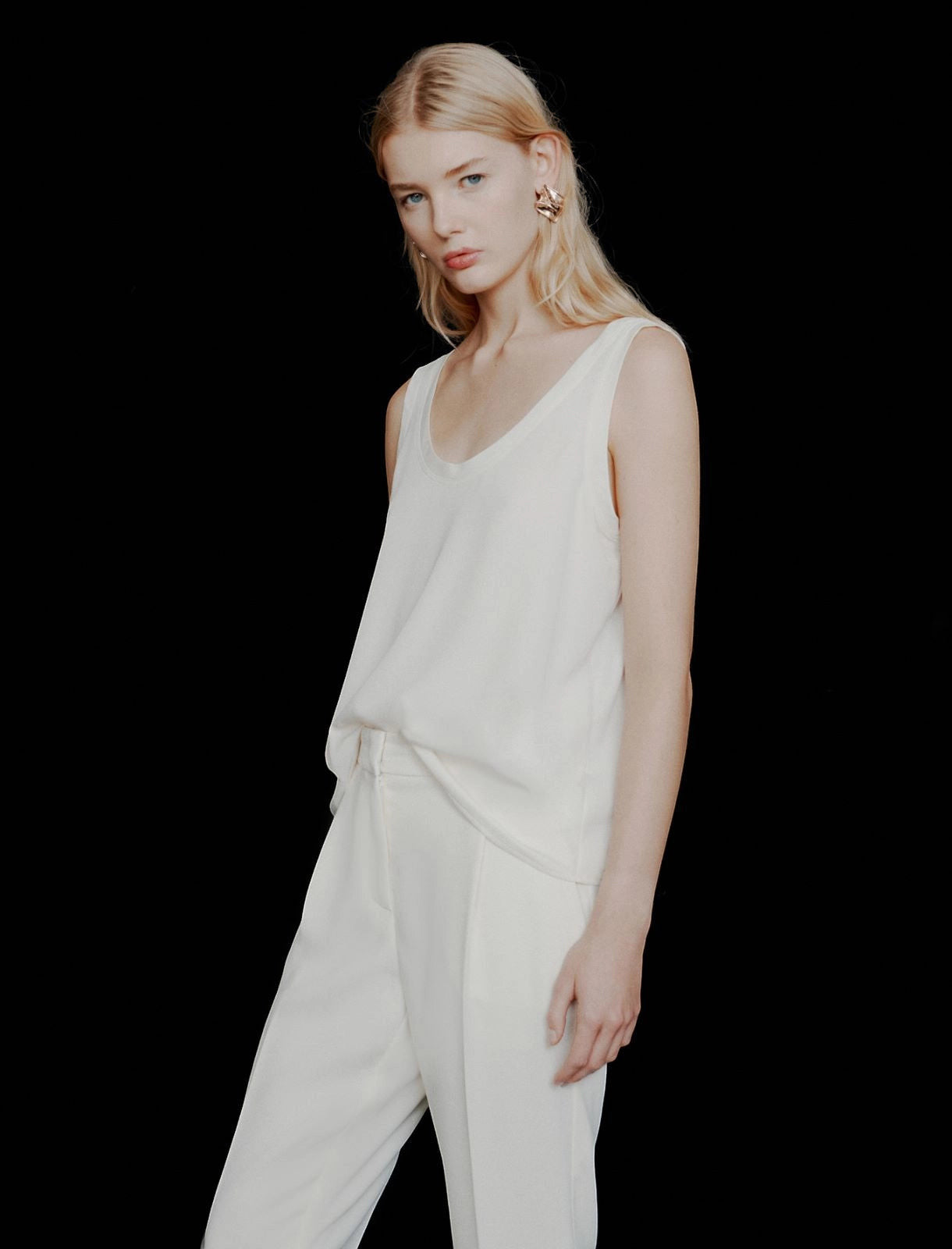 MiLA Boutique light ivory satin vest top with rounded neckline and spaghetti straps, paired with cream trousers.
