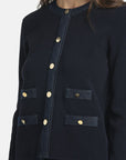MiLA Boutique navy blue knit cardigan with denim trim, gold buttons, and pocket details. Round neckline.