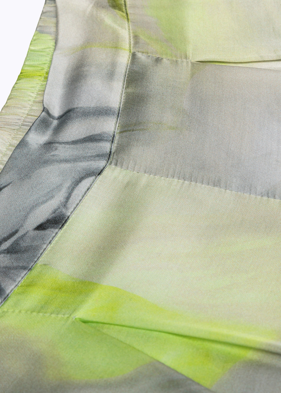 MiLA Boutique wide-leg satin trousers with abstract rose print in pale green and grey, featuring a relaxed fit and elegant drape.