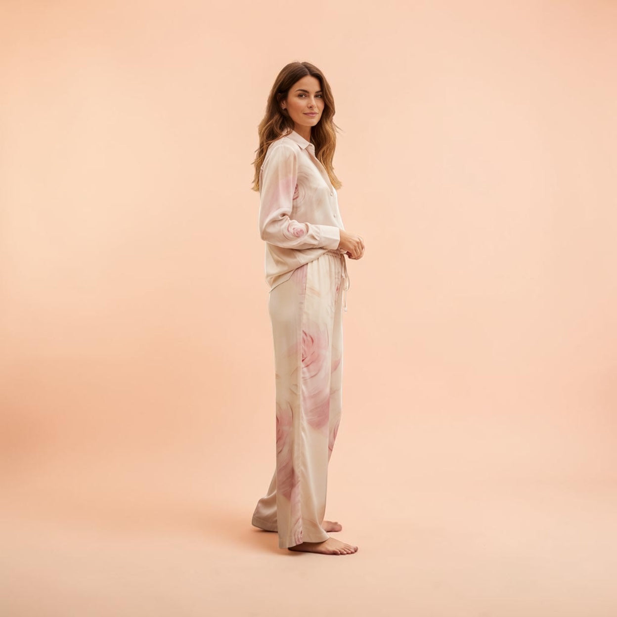 Blugirl Blumarine wide-leg satin trousers with a delicate rose print, elasticated waistband, and drawstring. Beige with pink floral design.