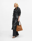 MiLA Boutique tan suede hobo bag with all-over Karl autograph embossment and padlock detail.