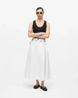 MiLA Boutique white A-line midi skirt with black button details and pockets, worn by a model.