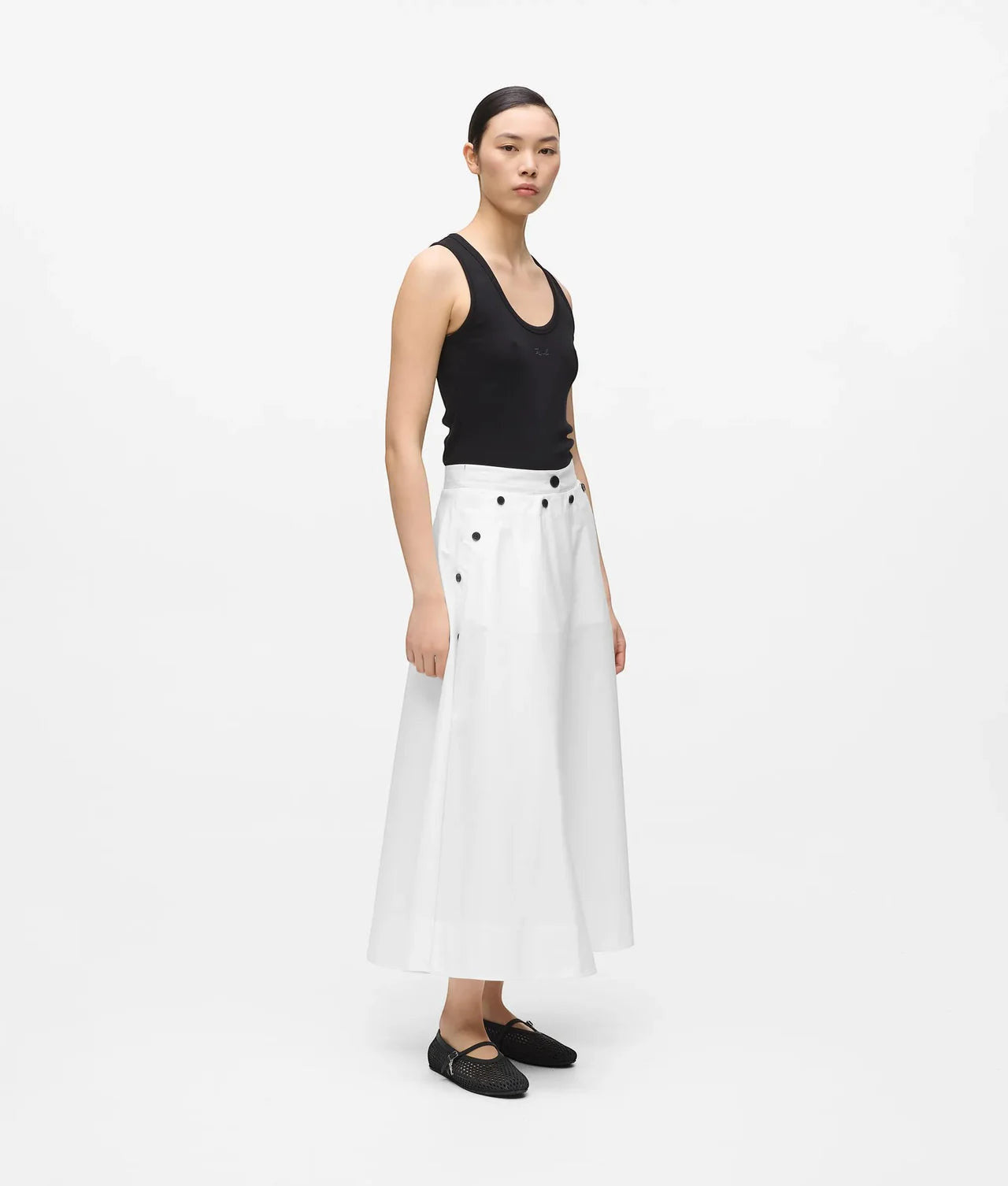 MiLA Boutique white A-line midi skirt with black button details and pockets, worn by a model.