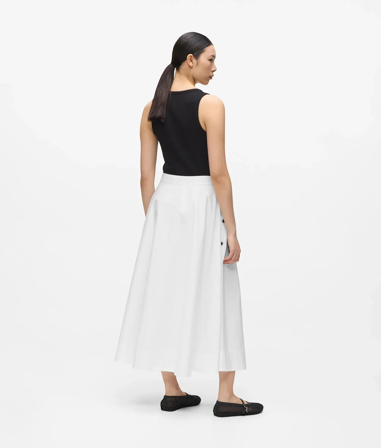 MiLA Boutique white A-line midi skirt with black button details and pockets, worn by a model.