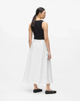 MiLA Boutique white A-line midi skirt with black button details and pockets, worn by a model.