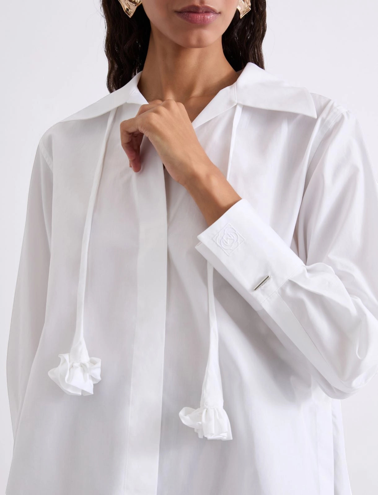 MiLA Boutique white cotton poplin shirt with a detachable neckerchief featuring ruffled ends and a fabric flower detail.