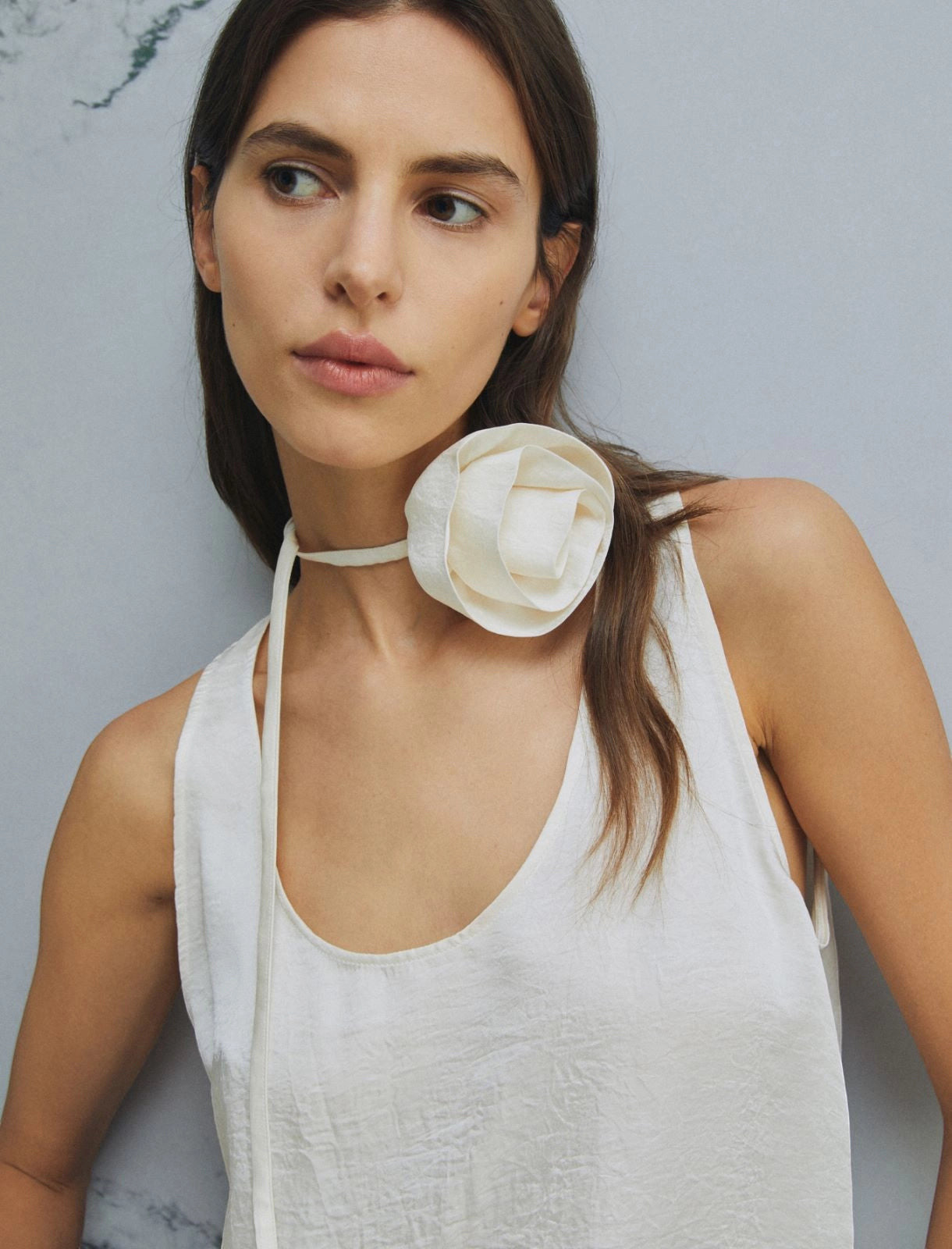 MiLA Boutique white crinkle twill sleeveless top with rounded neckline and fabric flower choker detail.