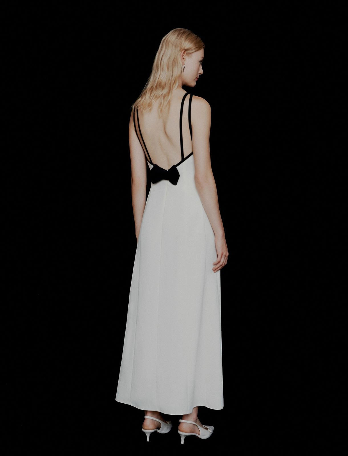 MiLA Boutique white envers satin backless maxi dress with black trim and bow detail, halterneck, elegant evening wear.