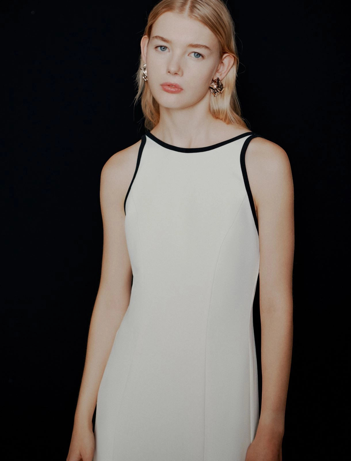 MiLA Boutique white envers satin halterneck dress with black trim and backless design.