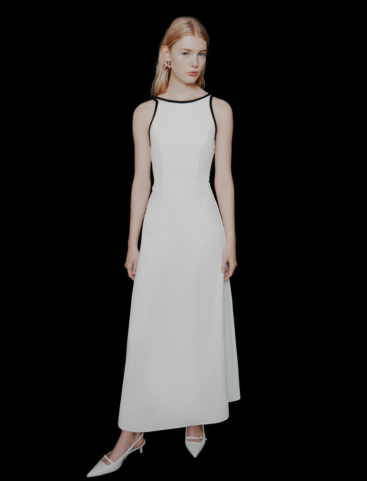 MiLA Boutique white envers satin maxi dress with black trim halterneck and backless design, worn by a model.